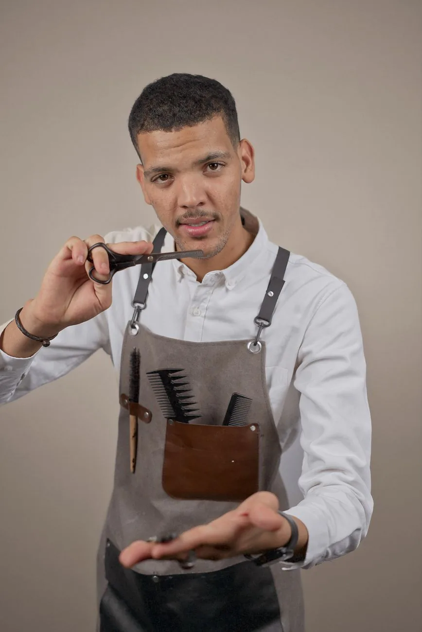  Julian Park, styling and treatment specialist, holding scissors in the salon